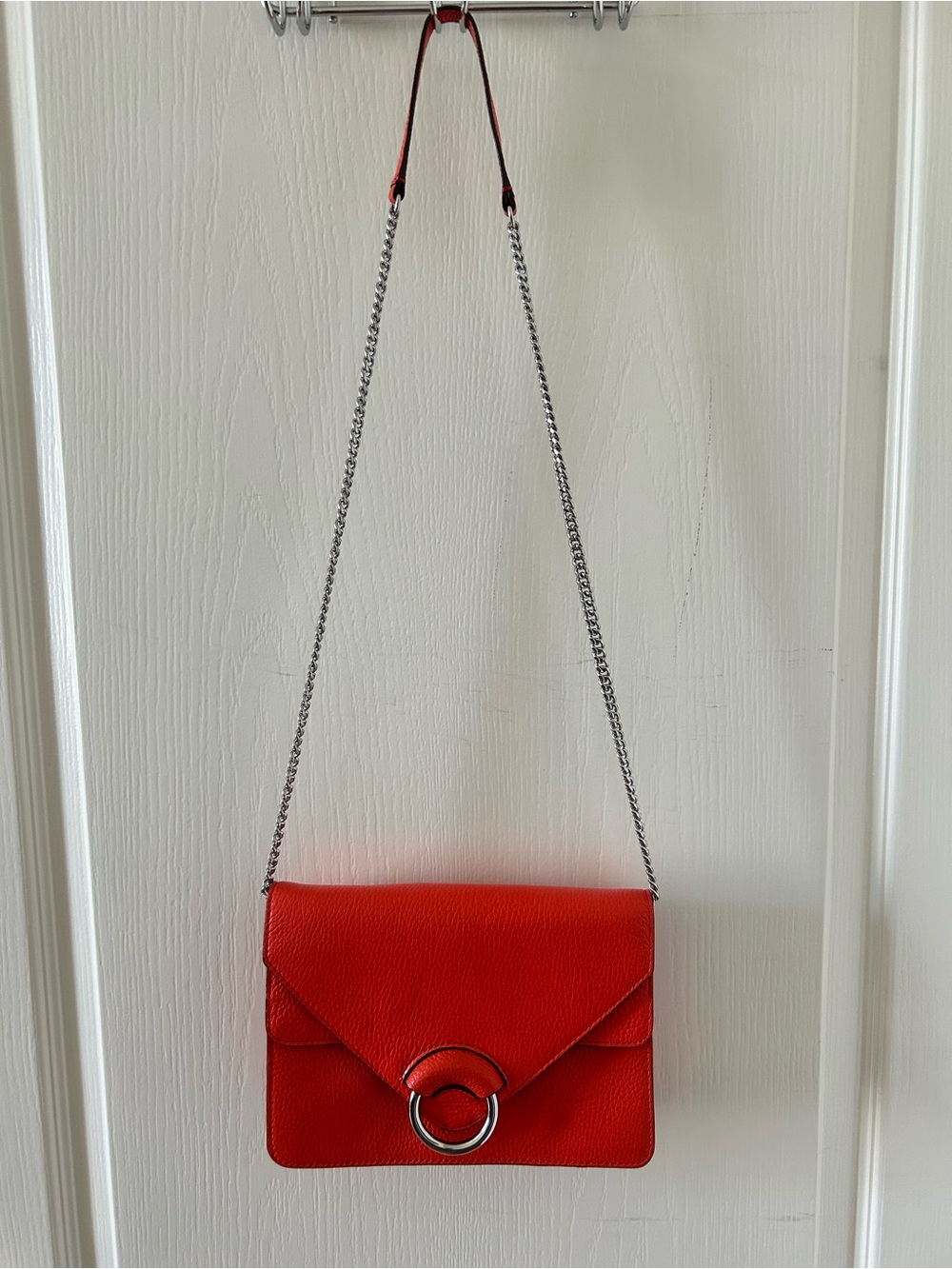 Vibrant Orange Leather Shoulder Bag with Silver Ring Accent & Chain Strap
